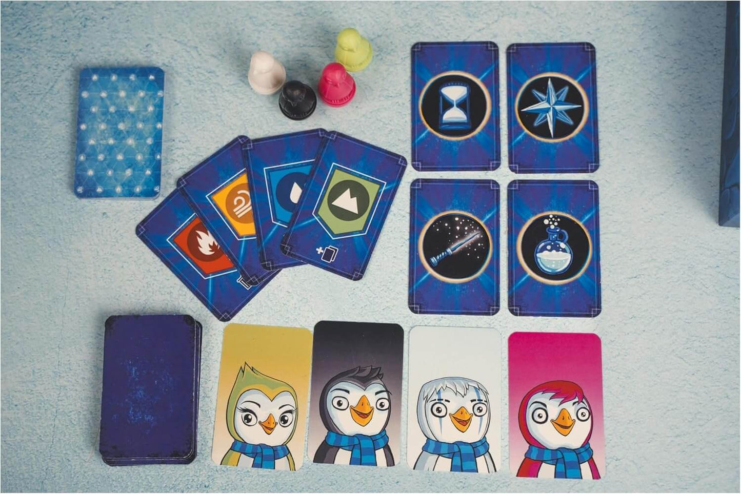Ice Cool Wizards game cards featuring colorful penguin characters and various game symbols on a blue background.
