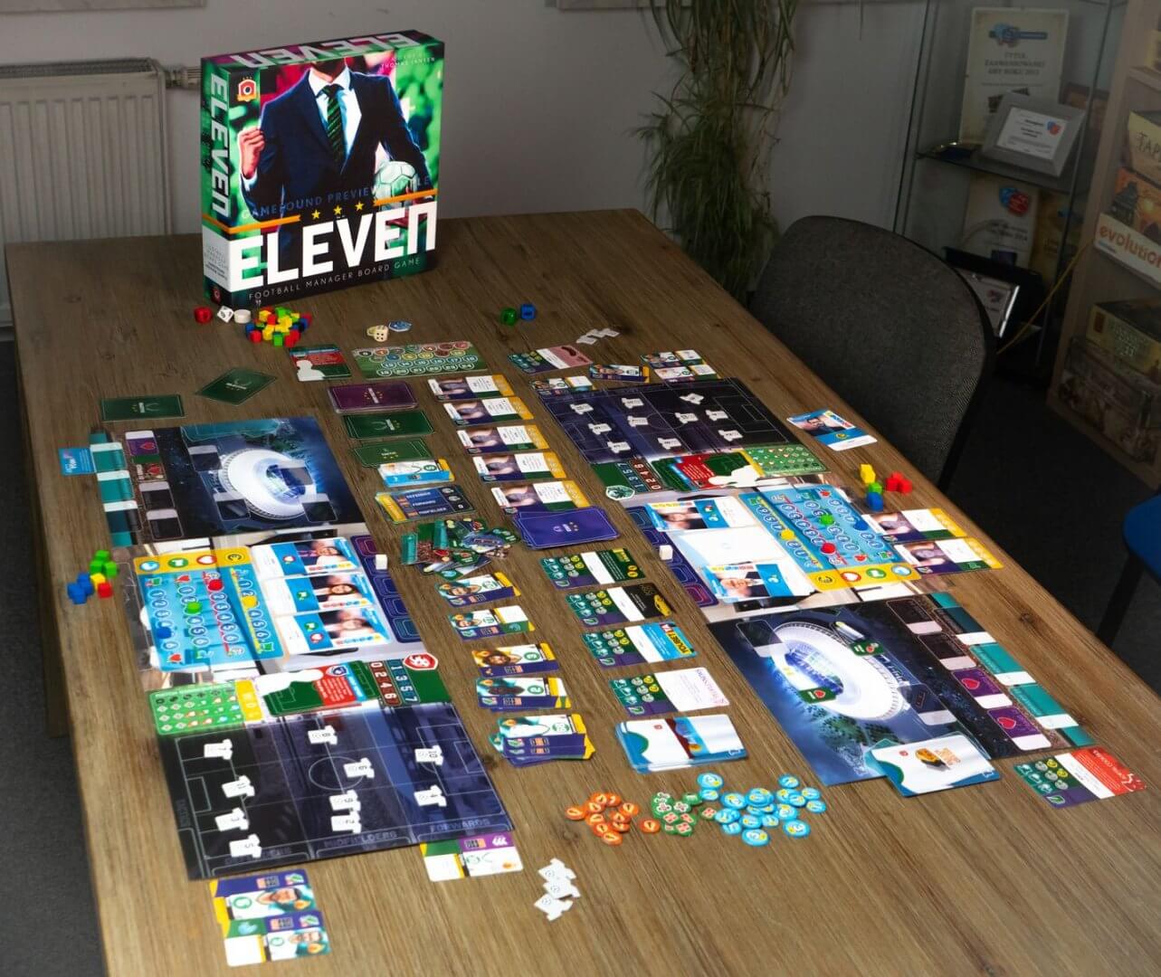 Eleven football manager board game set up on a table, featuring colorful game pieces and tactics boards.